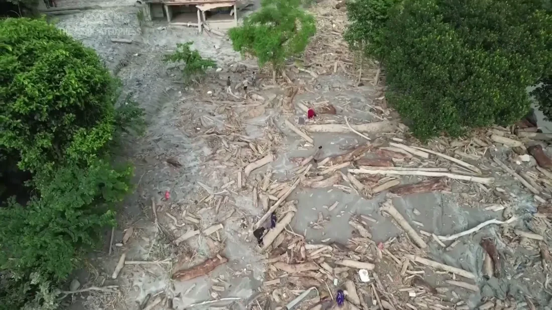 Flood debris along a riverbank in Nepal. Still from the supplied Associated Press video; recording date not provided.
