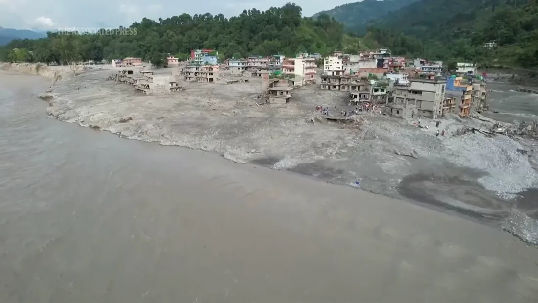 A riverside community surrounded by flood sediment in Nepal. Still from the supplied Associated Press video; recording date not provided.